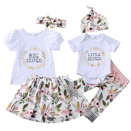 White 'Big Sister' top with floral skirt and 'Little Sister' bodysuit with floral pants and hat, matching sibling outfits. - Image 2
