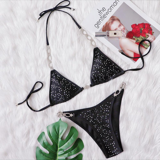 Black two-piece bikini with rhinestone chain halter straps and connectors, laid flat on white faux fur. - Image 6