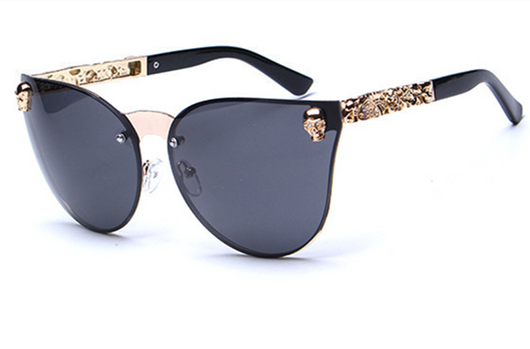 Pink mirrored cat-eye sunglasses with gold-toned frames, skull, and floral embellishments on the temples. - Image 7