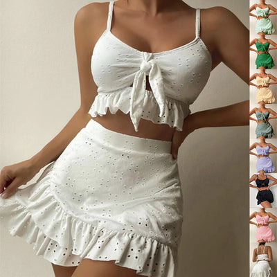 Light blue eyelet two-piece swimsuit set with a tie-front crop top and a matching ruffle-trim hip-hugging skirt.