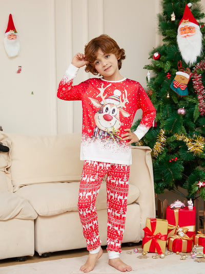 Family of four wearing matching red Christmas pajamas with reindeer and snowflake patterns, sitting on a sofa. - Image 10
