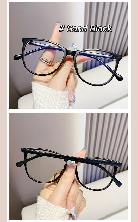 Black full-frame round anti-blue light glasses held by a hand with a gold ring and light blue gradient nails. - Image 19
