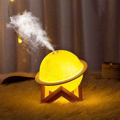 White moon-shaped humidifier with a textured surface resembling craters and a thin ring around its middle. - Image 5