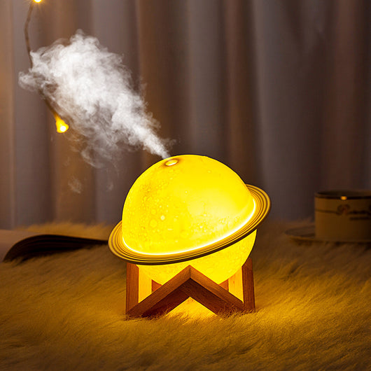 White moon-shaped humidifier with a textured surface resembling craters and a thin ring around its middle. - Image 5