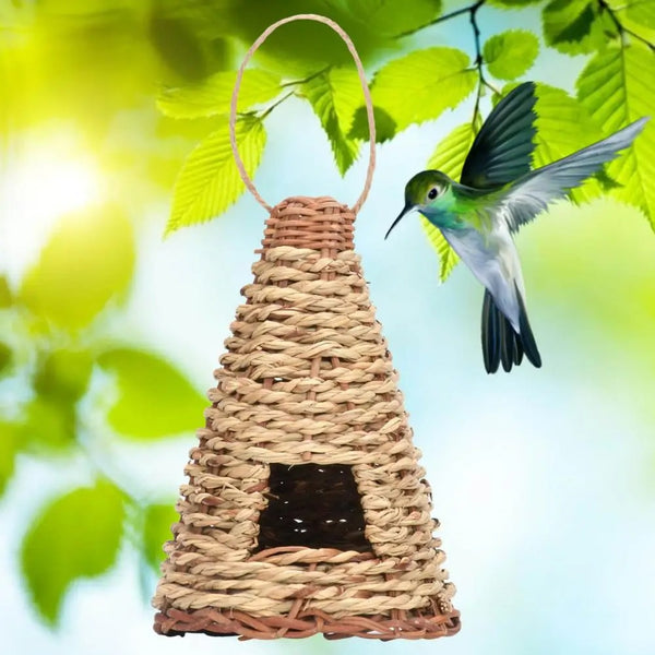 Cone-shaped, flat-bottomed bird's nest woven from natural straw with a small entrance and hanging loop.