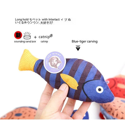 Orange fish-shaped plush catnip toy with blue fins and tail, held in a hand, with a small round tag. - Image 10