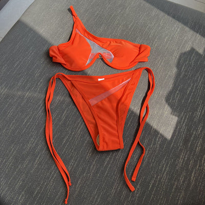 Orange one-shoulder bikini with sheer cutouts and side ties, modeled by a woman against a bright blue sky. - Image 8