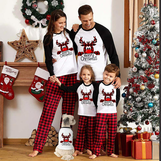 Family matching Christmas pajamas with a deer graphic and "Merry Christmas" text on white and black tops, paired with red and black buffalo plaid pants. - Image 4