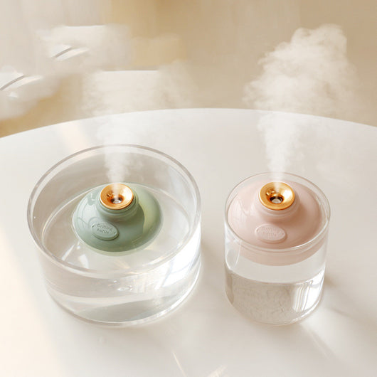 Three 'Drift bottle' humidifiers in white, mint green, and pink, floating in water and emitting mist. - Image 2