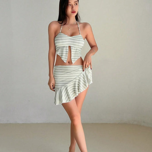 Woman in a light green and white striped two-piece swimsuit with a halter top and V-cut front hem. - Image 3