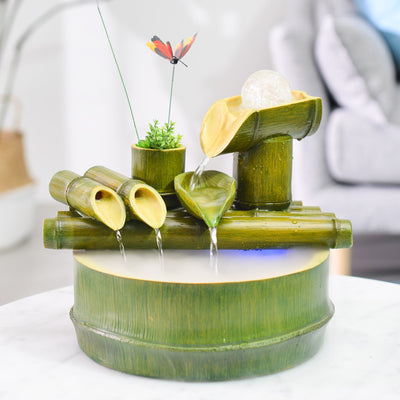 Green bamboo-themed indoor water fountain with multiple tiers, a water wheel, and small frog and butterfly accents. - Image 7