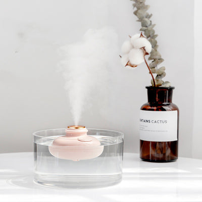 Three 'Drift bottle' humidifiers in white, mint green, and pink, floating in water and emitting mist. - Image 10