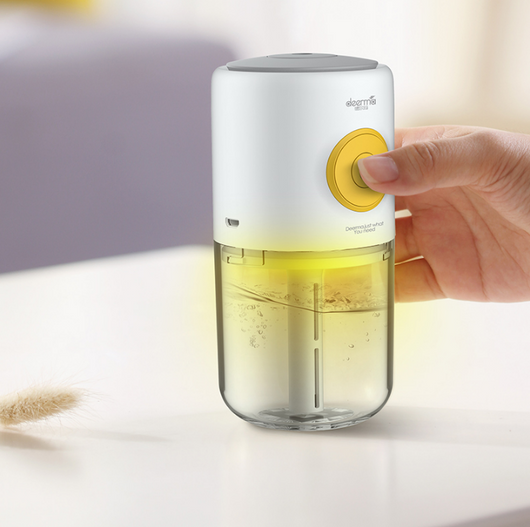 White and clear mini USB ultrasonic mist aroma essential oil diffuser with a yellow power button and gray top. - Image 3