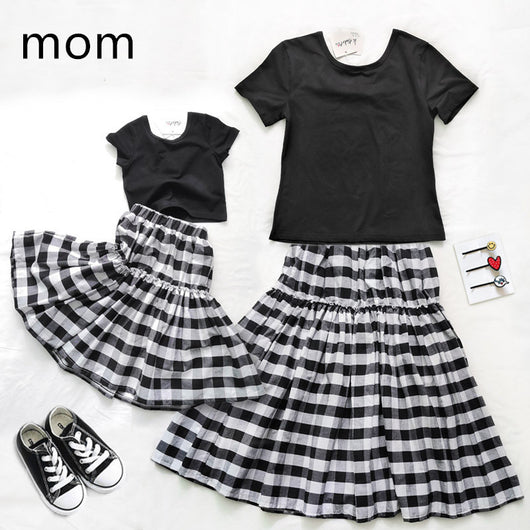 Matching black and white gingham two-piece outfits, one adult and one child size, with black short-sleeve tops and tiered skirts. - Image 14