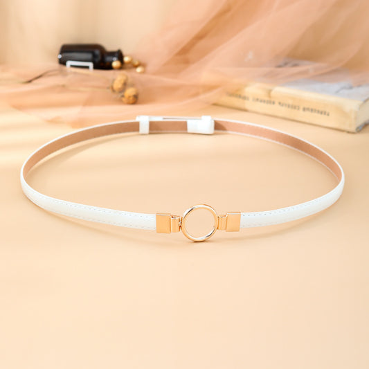 Black imitation leather belt with a glossy finish and a gold-tone round double buckle.