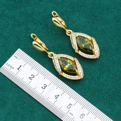 Gold-toned jewelry set with green marquise gemstones and clear accents, including a bracelet, necklace, earrings, and ring. - Image 7