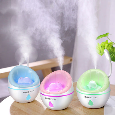 Blue and white mini humidifier with a cute white animal figure inside, suitable for car or desk.