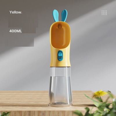 Grey and white portable pet water bottle with clear reservoir, built-in drinking bowl, and decorative bunny ears. - Image 12