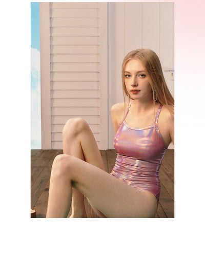 Woman wearing a shiny pink iridescent one-piece swimsuit with thin straps, ideal for racing or surfing. - Image 8