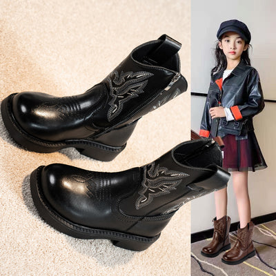Girls' brown Martin boots with white ethnic embroidery, side zippers, and black soles, displayed on a light carpet. - Image 4