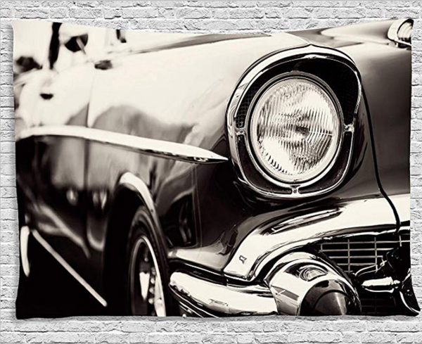Black and white tapestry featuring a close-up of a vintage car's headlight and chrome bumper.
