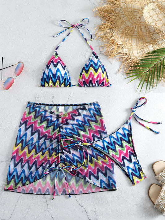 Three-piece printed swimsuit with a red and teal abstract pattern, featuring a halter bikini top, bottom, and mesh wrap skirt with drawstring. - Image 2