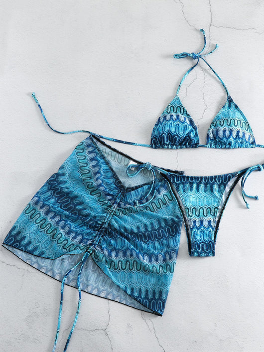 Three-piece printed swimsuit with a red and teal abstract pattern, featuring a halter bikini top, bottom, and mesh wrap skirt with drawstring. - Image 12