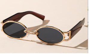 Retro small frame sunglasses with gold round frames and leopard print temples, held by a hand. - Image 11