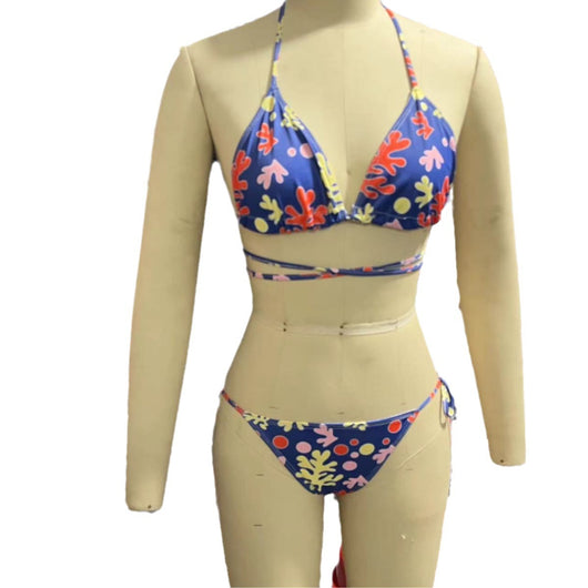 Woman in a light blue patterned triangle bikini with tie-side bottoms on a sandy beach with palm trees. - Image 5