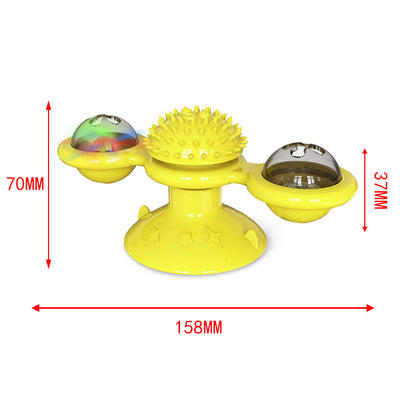 Green windmill cat toy with suction cup base, spinning arms, textured ball, and colorful lights, being played with by a tabby cat. - Image 9