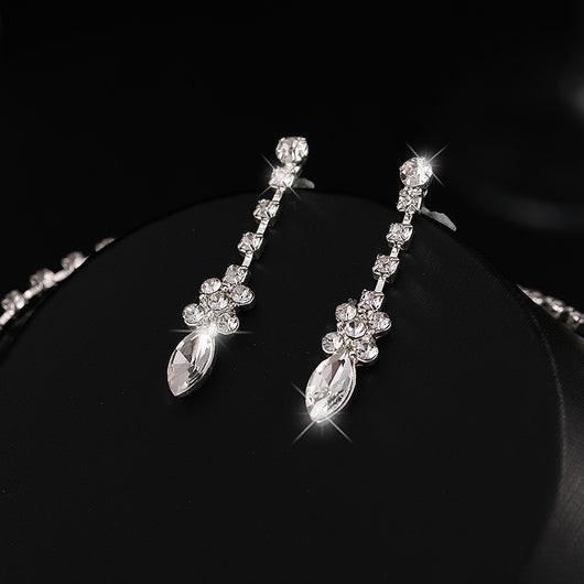Elegant silver-tone necklace and matching drop earrings set with clear marquise and teardrop stones, displayed on a black bust. - Image 2