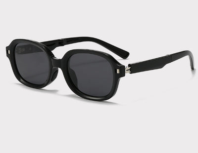 Brown oval sunglasses with dark lenses and thick frames, featuring visible silver hinges on a light gray background. - Image 7