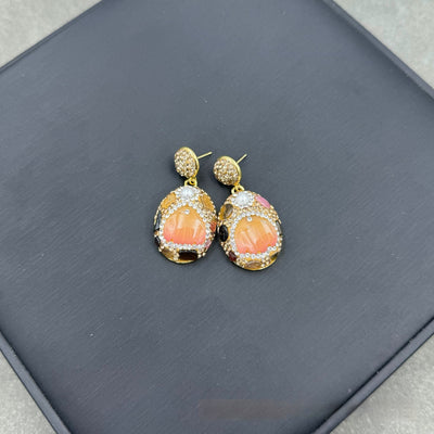 Gold-toned dangle earrings with oval drops, featuring a carved pink flower, clear rhinestones, and multi-colored tourmaline. - Image 3