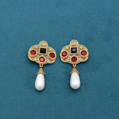 Vintage gold-toned necklace with double chain, ornate pendant featuring red and black glass inlays, and three white pearl tassels. - Image 10
