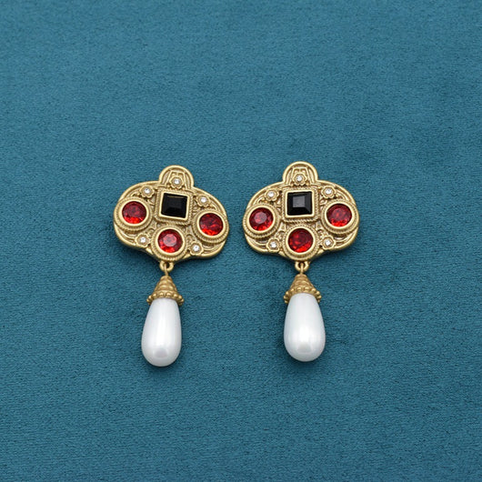 Vintage gold-toned necklace with double chain, ornate pendant featuring red and black glass inlays, and three white pearl tassels. - Image 10