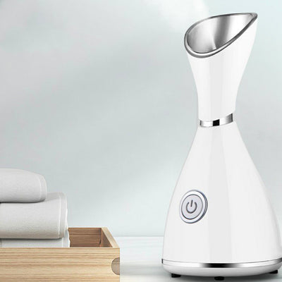 White facial steamer with a silver-toned steam nozzle and a prominent power button on the front, designed for home skincare. - Image 9