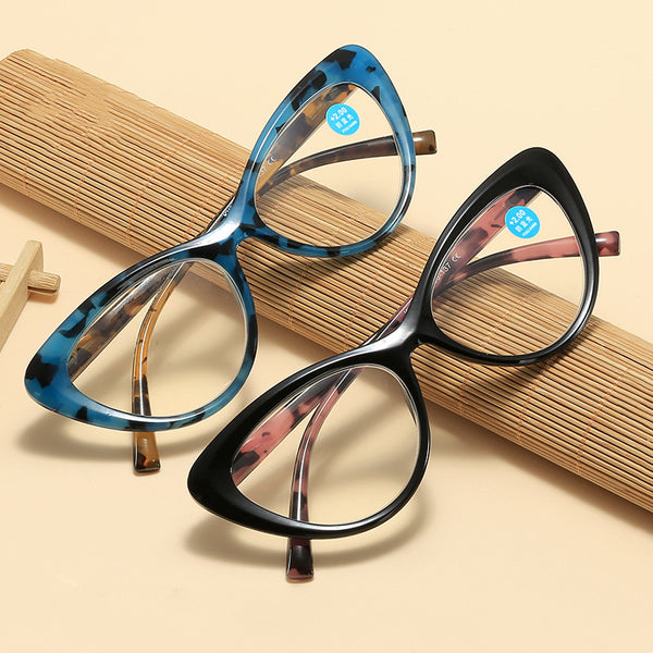 Black cat-eye anti-blue light reading glasses with green patterned temples on a white background.