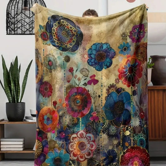 Bohemian flannel blanket with vibrant blue, red, purple, and gold floral patterns on a distressed beige background.