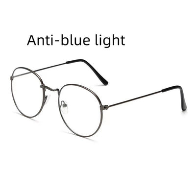 Retro oval anti-blue light glasses with a dark metal frame and clear lenses on a white background. - Image 9