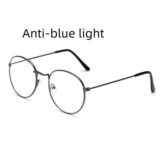 Retro oval anti-blue light glasses with a dark metal frame and clear lenses on a white background. - Image 9