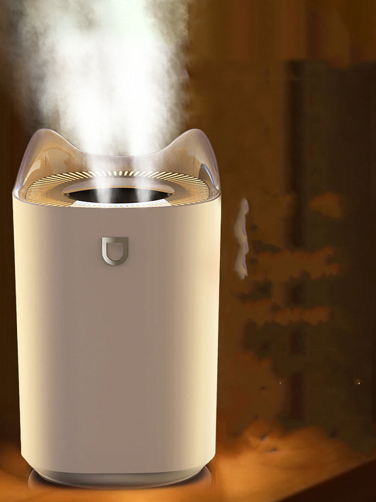 Beige double nozzle humidifier with cat ear design emitting mist, shown in a warm-toned indoor setting. - Image 10