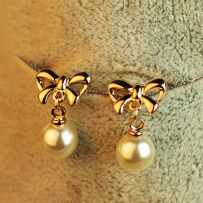Aretes Elegantes de Corazón con Moño de Circonia y Perla - Image 8