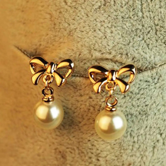 Aretes Elegantes de Corazón con Moño de Circonia y Perla - Image 8