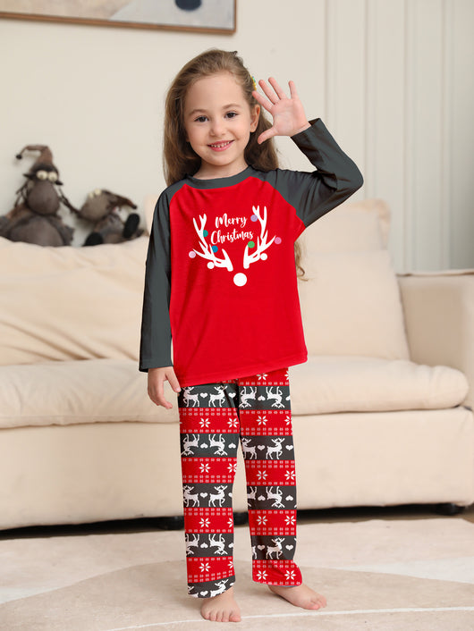 Family of four wearing matching red and black Christmas pajamas with a deer head and "Merry Christmas" print. - Image 4