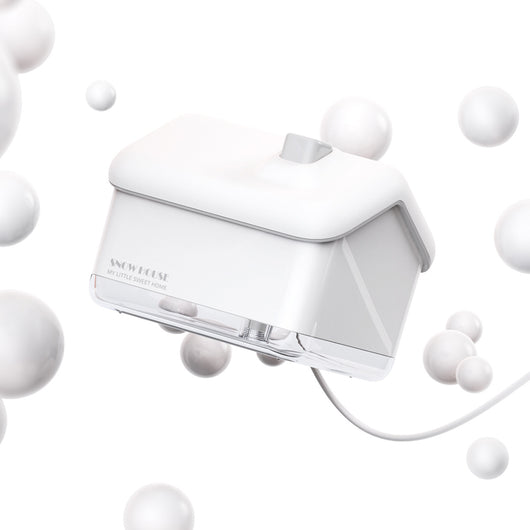 Pink and white house-shaped mini air humidifier with a clear base, a white roof, and a USB cable. - Image 3