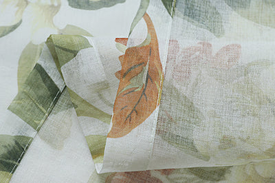 Dark gray semi-sheer curtains with a white and green floral pattern, hung on a black rod in a living room. - Image 11