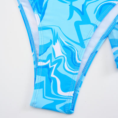 Red, orange, and white abstract swirl print three-piece bikini set with matching shorts, shown with a straw hat and sunglasses. - Image 22