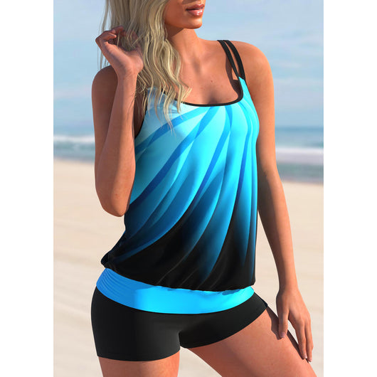 Plus size black tankini top with vibrant pink and blue butterfly print, paired with black swim shorts, on a beach. - Image 4