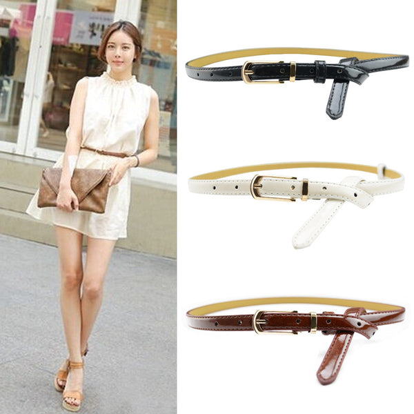 White patent leather women's belt with a slim strap and a gold-tone rectangular pin buckle.