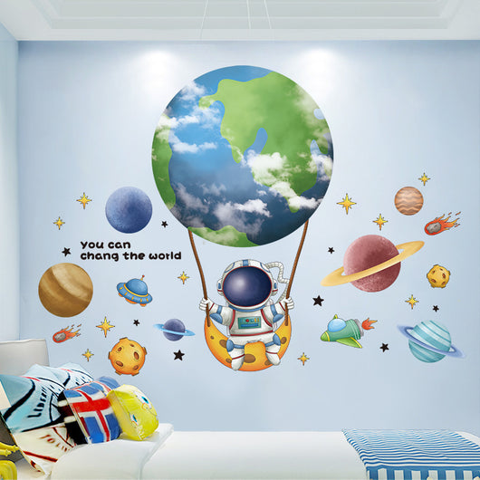 Cartoon astronaut and space station wall stickers with planets, stars, moon, and telescope on a white wall.